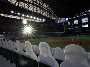 Cardboard cut-out images of fans are seen as the sun sets in the third inning of play between the Colorado Rockies and the Texas Rangers on Opening Day at Globe Life Field on July 24, 2020 in Arlington, Texas.