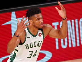 Milwaukee Bucks forward Giannis Antetokounmpo (34) reacts after making a basket against the Miami Heat at ESPN Wide World of Sports Complex.