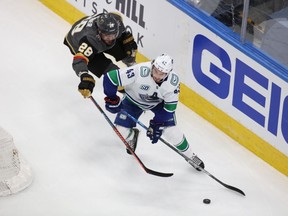 Aug 23, 2020; Edmonton, Alberta, CAN; Vancouver Canucks defenseman Quinn Hughes (43) chases the puck against Vegas Golden Knights left wing William Carrier (28) during the third period in game one of the second round of the 2020 Stanley Cup Playoffs at Rogers Place. Mandatory Credit: Gerry Thomas-USA TODAY Sports