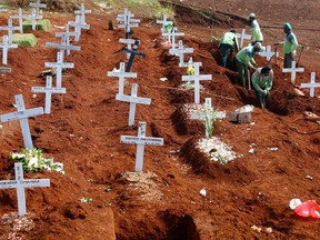 Workers prepare new graves at the Christian burial area provided by the government for victims of COVID-19 at Pondok Ranggon cemetery complex in Jakarta, Indonesia, Sept. 16, 2020.