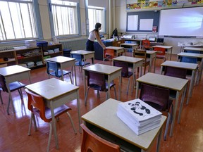 Grade one teacher Heidi Dimou arranges the desks in line with physical distancing policy in her class in preparation for the new school year at the Willingdon Elementary School in Montreal, on Wednesday, Aug. 26, 2020.