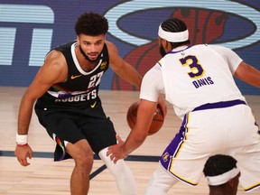 Lake Buena Vista, Florida, USA; Denver Nuggets guard Jamal Murray (27) dribbles the ball against Los Angeles Lakers forward Anthony Davis (3) during the second half of game three of the Western Conference Finals of the 2020 NBA Playoffs at AdventHealth Arena.