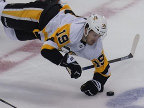 Penguins forward Jared McCann is tripped up during NHL Playoff action against the Canadiens in the third period of the Eastern Conference qualifications at Scotiabank Arena in Toronto, Aug. 7, 2020.