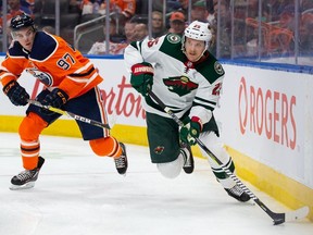 Jonas Brodin of the Minnesota Wild skates away from Connor McDavid of the Edmonton Oilers at Rogers Place on October 30, 2018 in Edmonton.