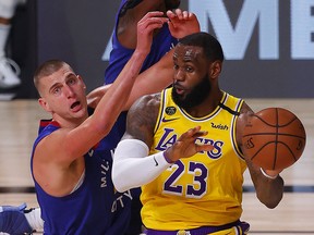 LeBron James of the Los Angeles Lakers passes against Nikola Jokic of the Denver Nuggets during Game 1 of the Western Conference Finals at the ESPN Wide World Of Sports Complex on September 18, 2020 in Lake Buena Vista, Florida.