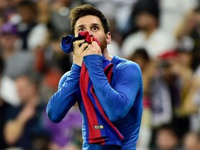 In this file photo taken on April 23, 2017 Barcelona's Lionel Messi kisses his jersey after brandishing it to celebrate his goal at the Santiago Bernabeu stadium in Madrid.