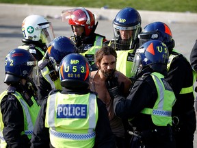 A man is detained during a demonstration in Trafalgar Square against the lockdown imposed by the government  in London, September 19, 2020.