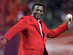 Baseball Hall of Famer and former St. Louis Cardinal Lou Brock throws out the ceremonial first pitch before the Cardinals met theTexas Rangers in Game 2 of MLB's World Series baseball championship in St. Louis, Missouri, Oct. 20, 2011.