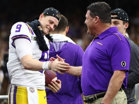 LSU Tigers head coach Ed Orgeron celebrates with quarterback Joe Burrow (9) after defeating the Clemson Tigers in the national championship game at Mercedes-Benz Superdome.
