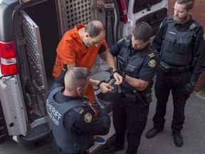 Matthew Vincent Raymond, charged with four counts of first degree murder, arrives at provincial court in Fredericton, Aug. 27, 2018.