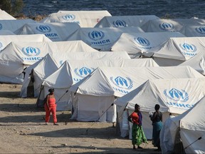 Refugees and migrants from the destroyed Moria camp are seen inside a new temporary camp, on the island of Lesbos, Greece, September 14, 2020.