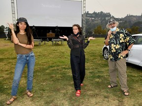 From left to right, Chloe Zhao, Frances McDormand, and Fox Searchlight Co-Chairman Stephen Gilula attend the drive-in premiere of "Nomadland" hosted by Fox Searchlight and The Telluride Film Festival at Rose Bowl in Pasadena, Calif., Friday, Sept. 11, 2020.