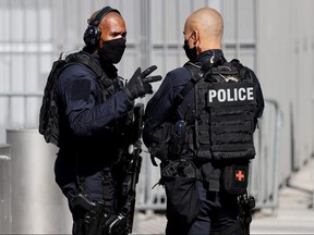 Police officers patrol outside Paris' courthouse, on September 2, 2020, on the opening day of the trial of 14 suspected accomplices in Charlie Hebdo jihadist killings.