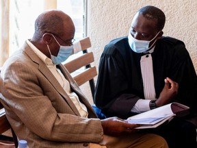 Paul Rusesabagina, portrayed as a hero in a Hollywood movie about Rwanda's 1994 genocide, talks to his lawyer, Rugaza David, inside the Kicyikuri primarily court in Kigali, Rwanda September 14, 2020.