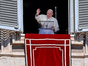 Pope Francis waves to worshipers from the window of the apostolic palace overlooking St. Peter's Square in The Vatican, Sunday, Sept. 6, 2020.