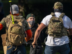 Right wing demonstrators chase a Black Lives Matter protester after a pro-Trump caravan rally convened at the Oregon State Capitol building on September 7, 2020 in Salem, Oregon.
