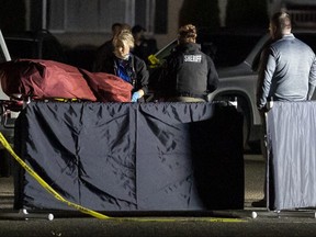 Investigators move the body of a man who is reportedly Michael Forest Reinoehl after he was shot and killed by law enforcement on September 3, 2020 in Lacey, Washington.
