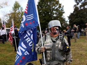 A woman that identifies herself as Momma Bear poses for a photo as people gather for a rally of the far right group Proud Boys, in Portland, Ore., Sept. 26, 2020.