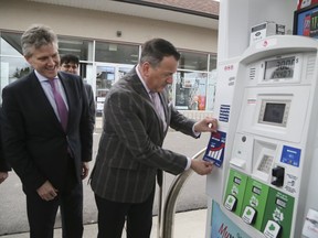 Rob Phillips, Minster of the Environment, Conservation and Parks, (L) and Greg Rickford, Minster of Energy, Northern Development and Mines, with an example of the sticker that will be placed on the pumps for participating gas stations was unveiled during a press conference on carbon tax for home heating and gas on April 8, 2019.