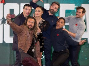 From left to right, Ezra Miller, Jason Momoa, Gal Gadot, Ben Affleck, Ray Fisher and Henry Cavill attend the London photocall for 'Justice League' at The College in London, Nov. 4, 2017.