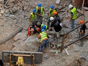 Rescue workers dig through the rubble of a badly damaged building in Lebanon's capital Beirut on September 4, 2020.