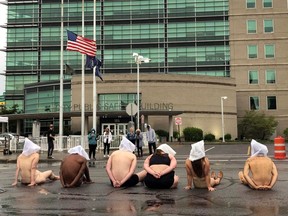 Naked and nearly naked protesters stage a demonstration to protest the death of Daniel Prude at Rochester's Public Safety Building in Rochester, N.Y., Monday, Sept. 7, 2020.