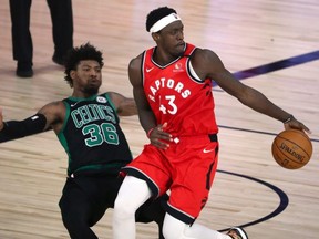 Boston Celtics guard Marcus Smart, left, fouls Raptors forward Pascal Siakam in Game 5 on Monday. Siakam needs to find his game fast. USA TODAY