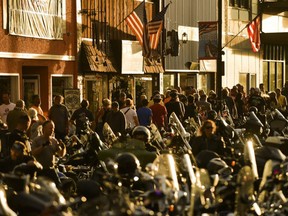People walk along Main Street during the 80th Annual Sturgis Motorcycle Rally in Sturgis, South Dakota, Aug. 8, 2020.