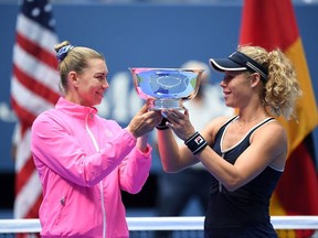 Vera Zvonareva of Russia and Laura Siegemund of Germany hold the championship trophy after their match against Yifan Xu of China and Nicole Melichar of the United States (both not pictured) in the women's doubles final on day eleven of the 2020 U.S. Open tennis tournament at USTA Billie Jean King National Tennis Center.