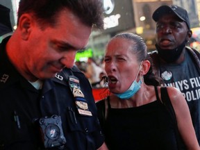 A woman argues with a police officer during a protest at Times Square in New York September 3, 2020.