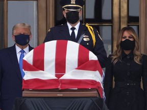 U.S. President Donald Trump and first lady Melania Trump pay their respects to Associate Justice Ruth Bader Ginsburg's flag-draped casket on the Lincoln catafalque on the west front of the U.S. Supreme Court in Washington, DC, on Sept. 24, 2020.