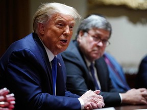 U.S. President Donald Trump, with Attorney General William Barr (right), speaks during a discussion with state attorneys general on protection from social media abuses in the Cabinet Room of the White House in Washington, D.C., Wednesday, Sept. 23, 2020.