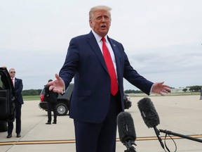 President Donald Trump talks to reporters as he disembarks from Air Force One on his way to Kenosha, Wisconsin after arriving at Waukegan National Airport in Waukegan, Illinois September 1, 2020.