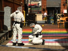Police forensics officers gather evidence on Hurst Walk, inside a cordon at Hurst Street, following a major stabbing incident in the centre of Birmingham, central England, on September 6, 2020. - One man was killed and two people were critically injured during a "random" stabbing attack lasting several hours in Britain's second city of Birmingham, police said on Sunday. Detectives said they were hunting one suspect after being called to reports of stabbings at four separate locations in the city centre between 12:30 am (2330 GMT Saturday) and 2:30 am. (Photo by Oli SCARFF / AFP) (Photo by OLI SCARFF/