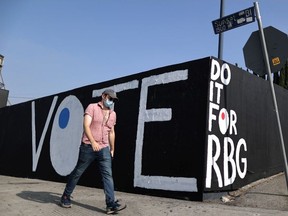A man walks past a tribute mural to the late Justice Ruth Bader Ginsburg in Los Angeles, California, U.S., September 21, 2020.