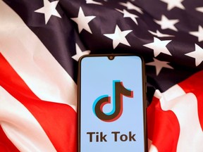 TikTok's logo is displayed on the smartphone while standing on the U.S. flag in this illustration picture taken, November 8, 2019.