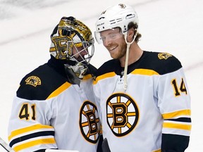 Boston Bruins right wing Chris Wagner (14) smiles while talking with goaltender Jaroslav Halak (41) after their win over the Carolina Hurricanes at Scotiabank Arena.
