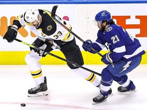 Zdeno Chara of the Boston Bruins and Brayden Point of the Tampa Bay Lightning battle for the puck during Game 5 at Scotiabank Arena on August 31, 2020 in Toronto.