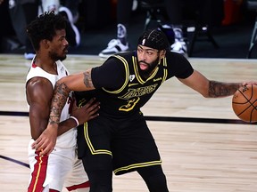 L.A. Lakers' Anthony Davis is defended by Miami Heat forward Jimmy Butler.
