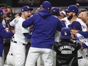 A.J. Pollock of the Los Angeles Dodgers celebrates with teammates after defeating the Tampa Bay Rays 3-1 in Game 6 to win the 2020 MLB World Series at Globe Life Field on Oct. 27, 2020 in Arlington, Texas.