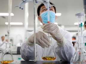 A man works in a laboratory of Chinese vaccine maker Sinovac Biotech, developing an experimental COVID-19 vaccine, during a government-organized media tour in Beijing, Sept. 24, 2020.