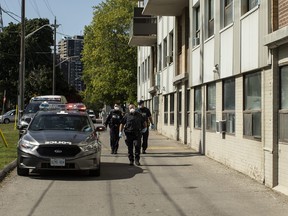 Police officers arrive at housing development in Toronto on Monday, Sept. 21, 2020.