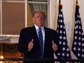 U.S. President Donald Trump gives two thumbs up from the Truman Balcony upon his return to the White House from Walter Reed Medical Center, where he underwent treatment for COVID-19, in Washington, D.C., on Oct. 5, 2020.