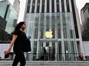 In this file photo taken on Sept. 28, 2020 a person walks past the Apple store on Fifth Avenue in New York City.