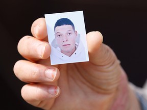 A relative holds an undated picture provided by the family of Brahim al-Aouissaoui, who is suspected by French police and Tunisian security officials of carrying out Thursday's attack in Nice, October 30, 2020.