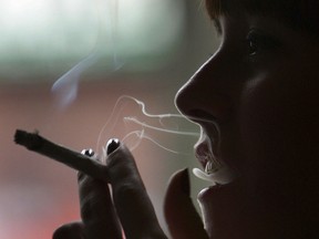 A woman smokes marijuana in a cafe on February 7, 2007 in Amsterdam, Netherlands.