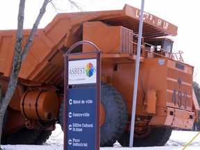 The town sign is seen in from of a mining truck in Asbestos, Que. on Wednesday, March 11, 2020. CP-Web.  The town sign is seen in from of a mining truck in Asbestos, Que. on Wednesday, March 11, 2020. he town of Asbestos, Que., looking to shed its link to mining town past for a new name has narrowed it down to four possible options. THE CANADIAN PRESS/Paul Chiasson ORG XMIT: JFJ104
