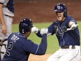 Tampa Bay’s Michael Brosseau celebrates with Yandy Diaz after his solo home run against the New York Yankees during Game 5 of the American League Division Series on Friday night. The Rays take on the Houston Astros in the ALCS. Getty images