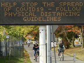 People get exercise along the lakeshore path on Lake Ontario on a fall day during the COVID-19 pandemic in Toronto, Tuesday, Sept. 29, 2020.