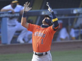 Houston Astros shortstop Carlos Correa (1) celebrates after hitting a home run against the Oakland Athletics during Game 1 of the 2020 ALDS at Dodger Stadium.